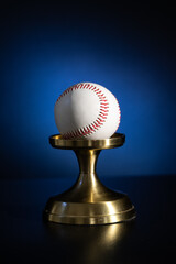 a baseball on a stand. Baseball equipment. Blue background