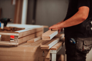 A skilled worker in the woodworking industry adeptly utilizes modern machinery to process and...