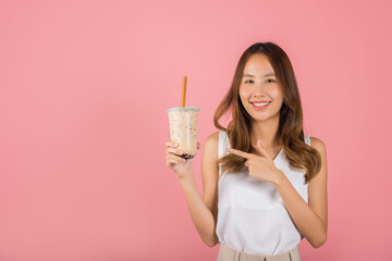 Pearl milk tea beverage concept. Asian beautiful young woman holding drinking brown sugar flavored...