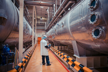 Male work inspection process milk powder cellar at the with horizontal  stainless steel tanks