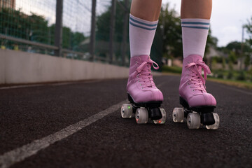 Close-up of an unknown man roller skating in the park on a sunny day, being on the road, spending time outdoors, enjoying a hobby during vacation, having fun. People and lifestyle concept.