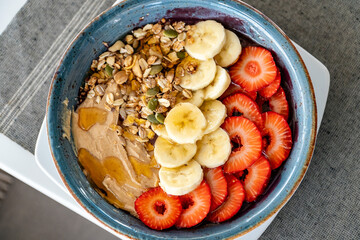 a close up birds eye view of a bowl of acai ice cream topped with fresh fruit and nuts 