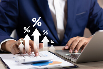 Interest rate concept, Business man using calculator with graph percentage symbol and up arrow, Growth of investments and profits, Dividends and long term investing to win Inflation, Calculate taxes.