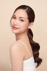 Beautiful young asian woman with clean fresh skin on beige background, Face care, Facial treatment, Cosmetology, beauty and spa, Asian women portrait.