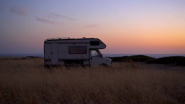 Motorhome wild camping near the sea at sunset