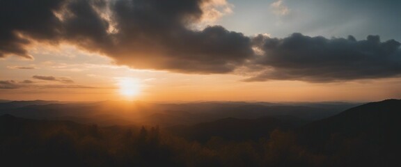 Obraz premium view of sunset and cloudy sky viewed from mountain top