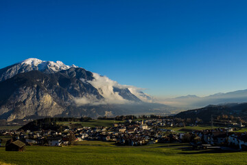 Scenic mountain landscape with a village nestled in lush green fields