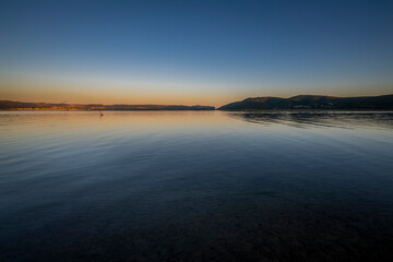 Knysna Lagoon with jetty and fishing boats at sunset in the Garden Route South Africa