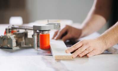 Process Gluing edge on machine to chipboard laminate board for production furniture in wooden carpentry