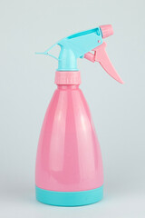 Mist sprayer for watering plants or spraying clothes. The pink bottle is made of plastic.