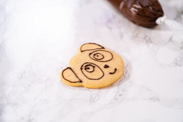 Panda shaped shortbread cookies with chocolate icing