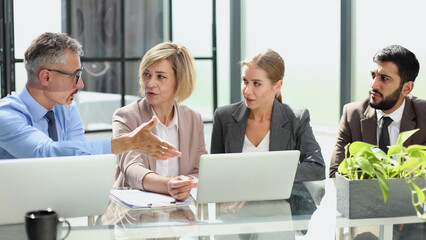 Portrait of creative business team using laptop