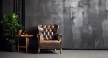Deurstickers Loft ambiance with a sleek leather armchair against a dark cement wall © Anna Lurye