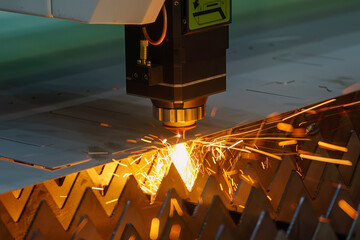 The fiber laser cutting machine  cut the metal plate with the sparkling light. - obrazy, fototapety, plakaty