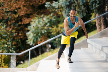 Good-looking dark-skinned athlete exercising on the stairs