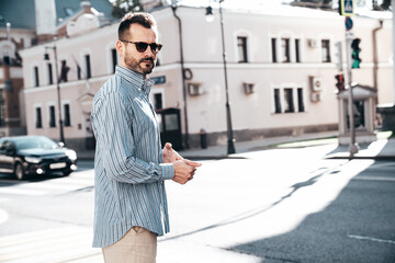 Portrait of handsome confident stylish hipster lambersexual model. Sexy modern man dressed in blue...
