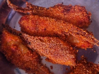 Crispy fried fish fillet with semolina seeds in plate