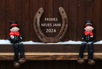 Frohes Neues Jahr 2024:   Schornsteinfeger und  Hufeisen  mit Glückwünschen zum neuen Jahr.