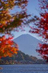 Beautiful landscape view of Mount Fuji with light falling through autumn leaves in Lake Kawaguchi