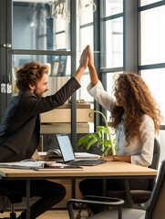 coworkers sharing a high - five in a modern, creative office space - obrazy, fototapety, plakaty
