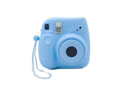 Ocala, Florida December 2, 2023 Light sky blue turquoise color Fujifilm instax mini 7 plus instant camera and ready made photos isolated on white grey background