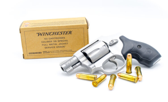 Ocala, FL November 29, 2023. Smith and Wesson silver 357 magnum revolver gun .38 caliber special with Winchester full metal cartridge ammo ammunition. Self defense weapon isolated on white background
