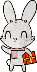 cute cartoon rabbit with christmas present