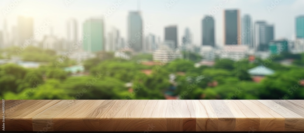 Aufkleber morning city background with blurred window glass garden green and wood table top for product displa