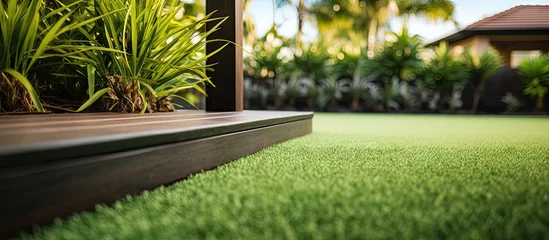 Fotobehang Modern Australian home with wooden edged artificial grass in the front yard Copy space image Place for adding text or design © vxnaghiyev