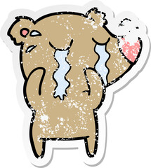 distressed sticker of a cartoon crying bear