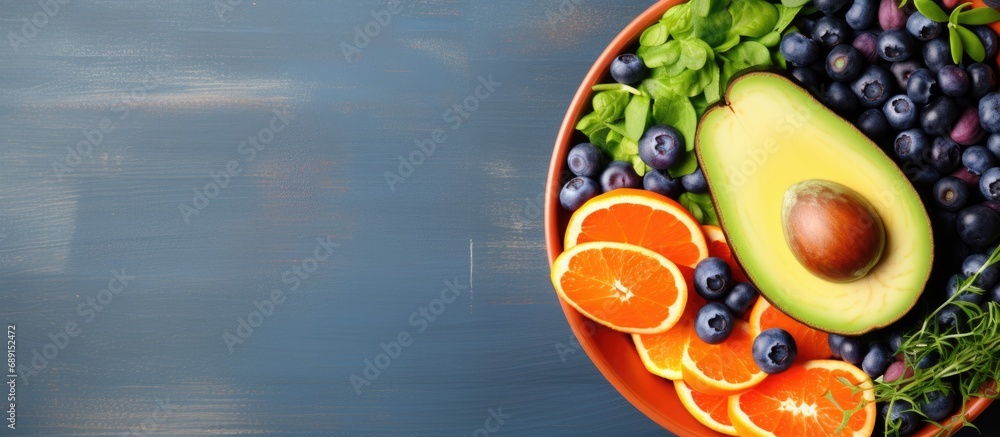 Aufkleber Dietary food bowl with sweet potatoes blueberries avocado cabbage and orange Top view with free space for text Copy space image Place for adding text or design