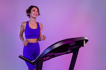 Photo of sporty girl sprinter use running machine on special offer buy for healthy bodycare...