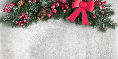 Fototapeta na wymiar Christmas holiday composition. Christmas fir tree branches, red berries on gray background. Xmas, winter, new year concept. Flat lay, top view, copy space