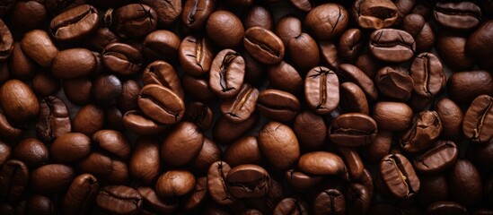 Fototapeta premium Close up view of coffee beans in the background Copy space image Place for adding text or design