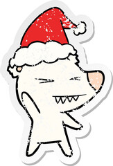 angry polar bear hand drawn distressed sticker cartoon of a wearing santa hat