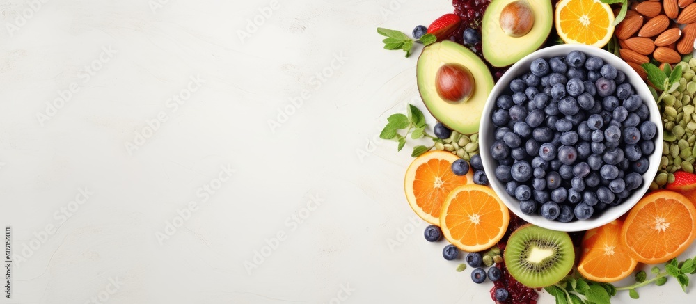 Poster dietary food bowl with sweet potatoes blueberries avocado cabbage and orange top view with free spac