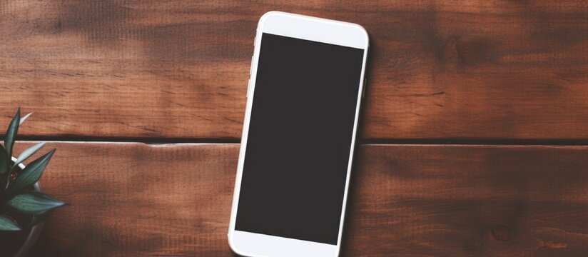 Mockup template of a blank screen mobile phone on a wooden side table Copy space image Place for adding text or design