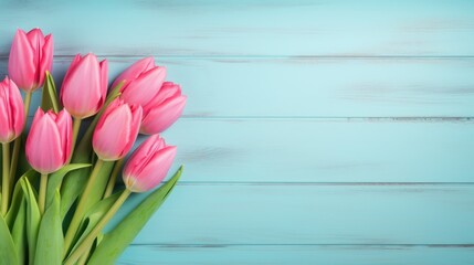 Pink tulip bouquet on a blue wooden background