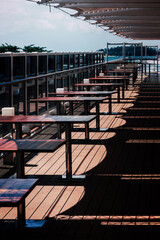 Tables on a Deck with a Railing on a cruise ship