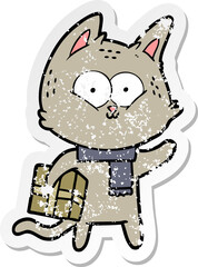 distressed sticker of a cartoon cat holding christmas present