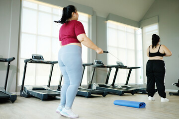 Young woman exercising in the fitness center, exercise concept. Lose weight.