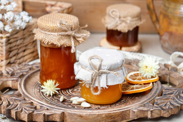 Jars of honey on wooden table.