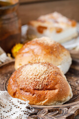 Sweet homemade buns on rustic wooden table. Delicious breakfast.