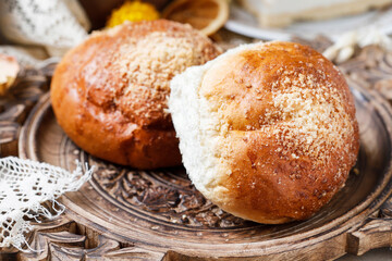 Sweet homemade buns on rustic wooden table. Delicious breakfast.