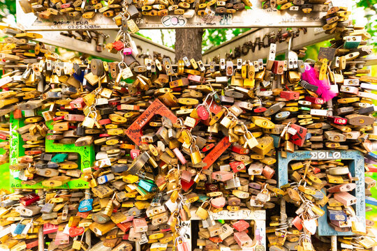 Paris, France - 23 February, 2023: Many wedding locks attached on a bridge