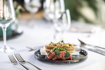 Steak Tartare with bread toasts served on a restaurant table