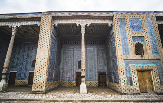 Facades of buildings covered with ceramic mosaic tiles, with wooden columns in the historical city of Khiva in Khorezm