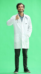 male doctor in a white coat on a green background shows a thumbs up sign