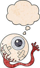 cartoon injured eyeball with thought bubble in grunge texture style