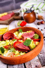fresh salad with salami and vegetables